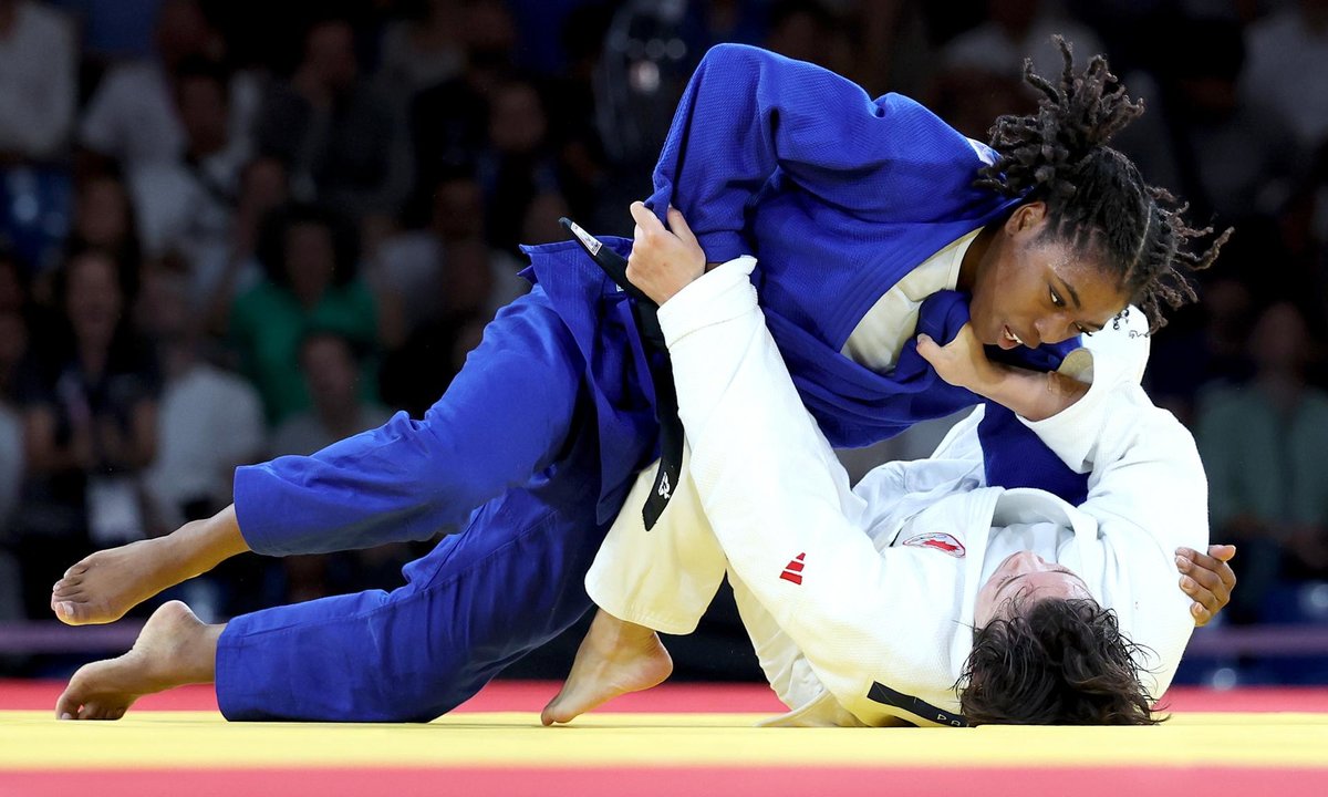 La francesa Sarah Leonie Cysique (azul) contra la canadiense Christa Deguchi en -57kg en el combate por el oro celebrado en el los Campos de Marte de París, Francia. EFE/EPA/DANIEL IRUNGU